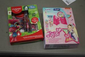 lot 302 image: Colgate Troll Brush Set, Spinbrush Orajel JoJo Siwa Brush Set