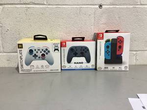 lot 674 image: 2 Nintendo Switch Wireless Controllers and 1 Joy-Con with Charging Dock
