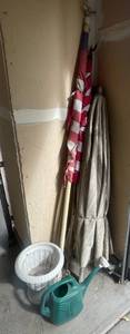 lot 296 image: Outdoor Garden Decor Lot with Flag, Umbrella, Planter, and Watering Can