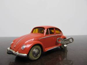 lot 53 image: Vintage SCHUCO Micro-Racer Race Car wKey - Salmon Colored Volkswagen wYellow Windows