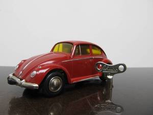 lot 56 image: Vintage SCHUCO Micro-Racer Race Car wKey - Red Volkswagen w Yellow Windows