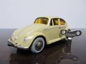 lot 57 image: Vintage SCHUCO&nbspMicro-Racer Race Car wKey - Light YellowCream Volkswagen YellowOrange Windows
