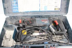 lot 45 image: Bosch Heavy Duty Hammer Drill 120 Volts Comes With Many Large Drill Bits In Original Case