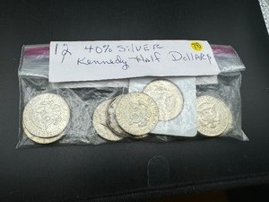 lot 76 image: Twelve 40% Silver Kennedy Half Dollars