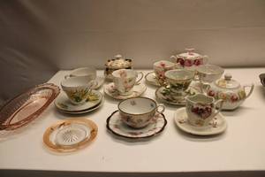 lot 13 image: Vintage Porcelain Teacup and Saucer Set with Floral Designs