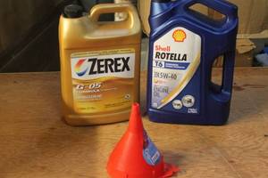 lot 132 image: Automotive Fluids Lot - Antifreeze, Engine Oil, and Funnel