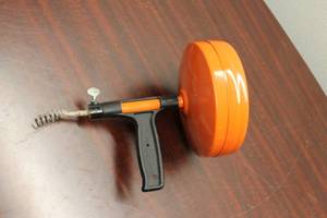 lot 627 image: Vintage Orange Drain Cleaner - Manual Snake Auger