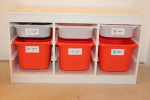 lot A-197 image: White Storage Unit with Red and White Bins