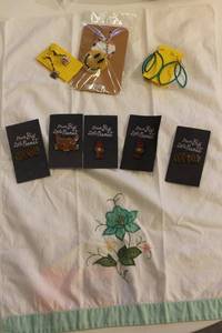 lot 375 image: Assorted Enamel Pins, Earrings, Keychain, and Embroidered Towel