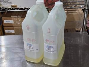 lot 38 image: Lot of 2 Fragrance Oils Peach Bellini and Nautica One is 20.8 Ounces and the Other 25.5 Ounces by Weight