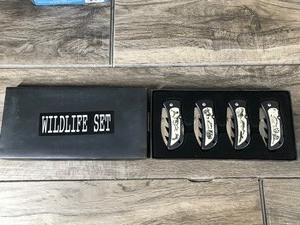 lot 90 image: Wildlife Knife Set of 4 with Deer, Bear, Wolves and Eagles Pictured on the Front