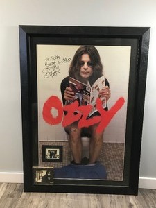 lot 404 image: Rare In Color Framed Autographed Poster Ozzy Osbourne On A Toilet 1992 Monowise LTD - Also has a picture of Ozzy with 2 other People and a CD with the Case Autographed inside