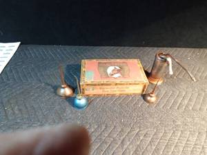 lot 603 image: 3 thumb press and 1 sm vintage oil can and a cigar box