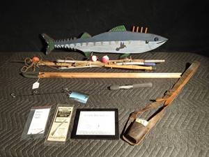 lot 570 image: 1950s Stream fishermans leather rod holder, ice fishing sticks, H S Hunters shooting stick, new North Star ice fishing rod, jackalope hunting permit, ghost ring sight, Remington wood master model 740 instruction manual permit