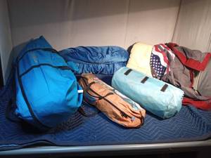 lot 327 image: Gander Mt. tent, Ozarks Trail tent, air mattress, sleeping bag, comforter, and sm. quilt