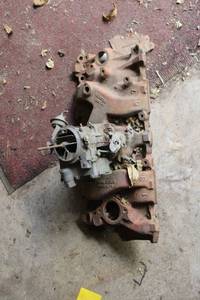 lot 53 image: Vintage Automotive Engine Intake Manifold with Carburetor