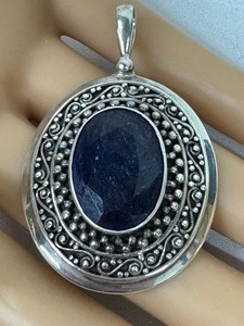 lot 214 image: Sterling Silver Oval Faceted Sapphire Pendant