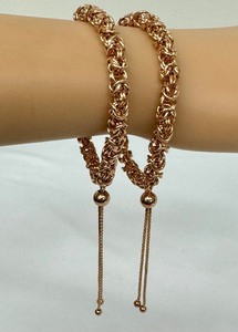 lot 244 image: Pair of Copper Colored Sterling Silver Bracelets