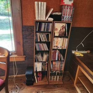 lot 24 image: Two CD, DVD And VHS Storage Racks, Including All CDs, DVDs And VHS Tapes As Seen In Photo Measuring 45 X 11 Inches Each