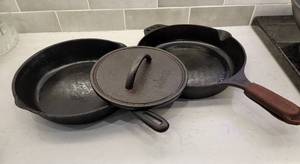 lot 93 image: Smithey and Taiwan Iron Skillets with Lodge Bacon Press