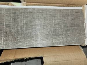 lot 124 image: 7 boxes roughcut lumber Greige peel and stick Vinyl plank flooring