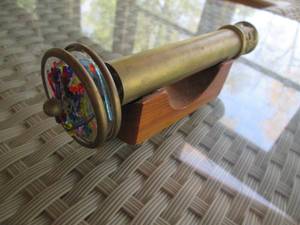 lot 318 image: Metal kaleidescope on a wood dtand...