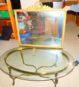 Four-Legged Round Golden Table With Glass Top With Framed Picture On Top