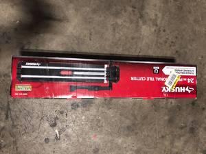 lot 39 image: Husky 24 in. Tile Cutter with Tungsten Carbide Blade and Adjustable Gauge Customer Returns See Pictures