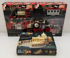 lot 84 image: F.A.O. Schwarz 30 Piece Motorized Train Set & 3D (St. Peters Basilica) Puzzle (Both Slightly Used In Original Box)