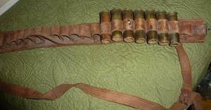 lot 15 image: Vintage leather ammo belt with some shotgun shells