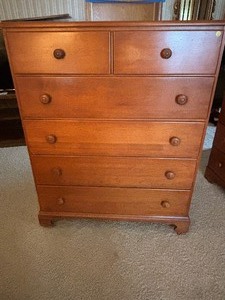 Tall Wooden Dresser has casters