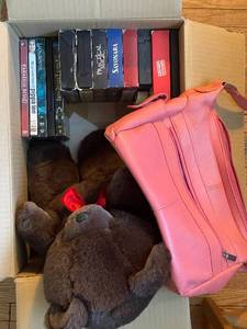 lot 48 image: Assorted Collection of DVDs and VHS Tapes with Plush Bear and Pink Handbag