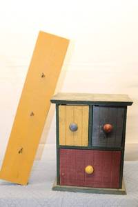 lot 34 image: Vintage Wooden Storage Cabinet with Colored Drawers and Matching Wall Rack