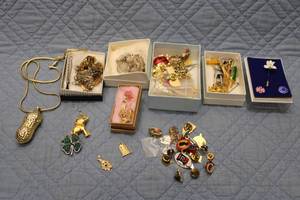 lot 351 image: Mixed Lot of Vintage Jewelry including Gold Peanut Pendant, Silver Bracelet, and Various Brooches