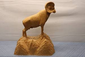 lot 412 image: Hand-Carved Wooden Mountain Ram Sculpture on Rocky Base