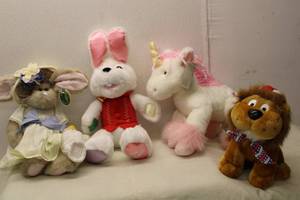 lot 571 image: Collection of 4 Stuffed Animals Lion, Bunny, Unicorn, and Vintage Rabbit