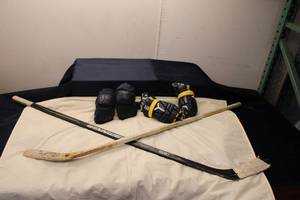 lot 86 image: Hockey Gear Set Including Winnwell Sticks, Protective Gloves, and Elbow Pads