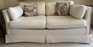 lot 46 image: Cozy Cream Sofa with Side Pillows and Skirted Base
