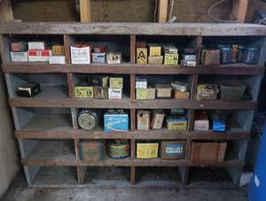 VINTAGE GARAGE SHELF FILLED WITH VINTAGE BOXES OF GOODIES