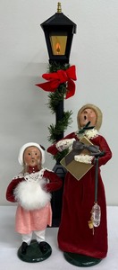 lot 211 image: Byers Choice Ltd - The Carolers - Woman with Gift and Young Girl with Fur Hand Muff-1989 - PLUS Street Lamp