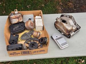 lot 244 image: Assortment of Vintage Small Engine Parts Mostly Mufflers - Various Components