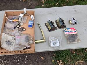 lot 372 image: Assortment of Mechanical Parts - Carburetor Mount Flange, Reed Valves (Used), and Various Components