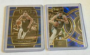 lot 38A image: Nikola Jokic 2 Card Lot w 2023-24 Select Blue Cracked Ice #169 and 2021-22 Select Blue Prizm Shimmer #82 Basketball Cards