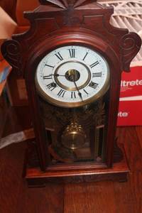 lot 259 image: Antique New Haven Clock Co. Alarm Clock with Decorative Glass Face and Wood Frame