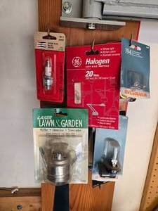 lot 125 image: Assortment of Light Bulbs and Lawn Equipment Parts - New