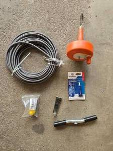 lot 175 image: Plumbing Repair Kit - Drain Snake, Threadlocker Blue, and Plumbing Accessories