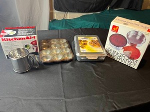 lot 300 image: Lot of Bakeware Inc MuffinCupcake Tin, Sifter, Bake Pan Set in Orig Box & KitchenAid Slicer