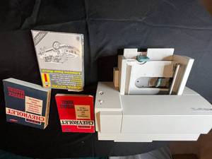 lot 307 image: HP DeskJet 672C Printer with 1973 Chevrolet Overhaul and Service Manuals untested