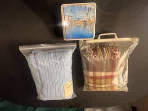 lot 337 image: Lot of 3 Items Plaid Throw Blanket, Blue Knitted Blanket, and Decorative Tin