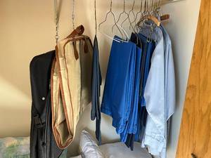 lot 613 image: Two Garment Bags and Lot of Blue Pants w Gray Uniform Shirts - see pics for sizes
